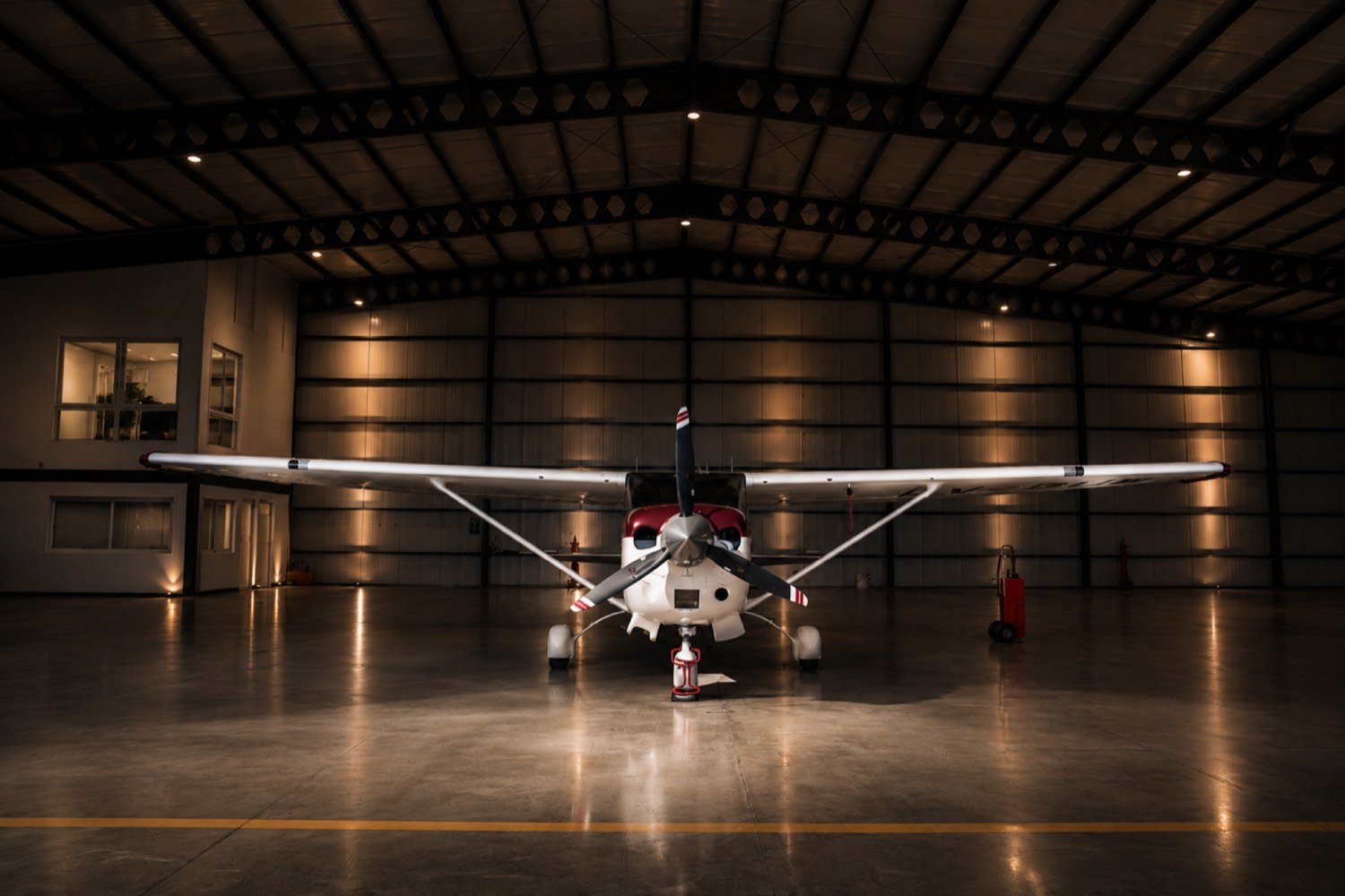 Cessna de frente dentro del hangar iluminado